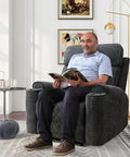 Man reading in dark gray Electric Power Recliner Chair With Soft Fabric Upholstery Overstuffed Heavy Duty Sofa Chair in living room.