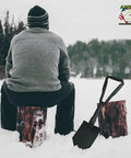 Rugged Folding Camping Shovel Set With ACU Pouch next to camper sitting on snow-covered logs in winter landscape