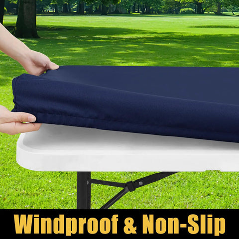 Hands fitting a navy waterproof elastic tablecloth with elastic edge onto a 6-foot table for outdoor use, spillproof windproof