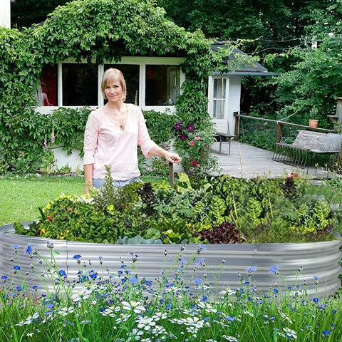 Woman tending plants in Two Pack Galvanized Raised Garden Bed Kit Oval Large Metal Planter Boxes for Outdoor Vegetable Garden