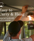 Person hanging Beast Bright 800 Lumen LED Lantern With USB Charging Ports using a carabiner under a canopy