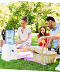 Family enjoying picnic with Portable Mini Cold Water Dispenser For Countertop Bottled Water Holder With Slip Design Easy To Clean Space Saving