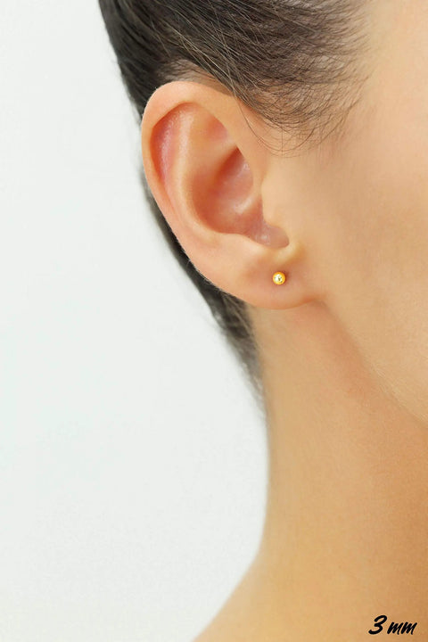 14K Yellow Gold Ball Stud Earrings With Secure ScrewBacks 3mm Tiny Round Earrings For Everyday Wear shown on ear