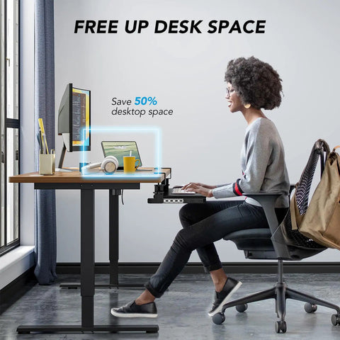Person using an under desk keyboard tray pull out with sturdy adjustable C clamp mount system at a workstation