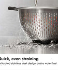 Non Slip Grip 5 Qt Stainless Steel Colander with Comfortable Handles for Pasta and Veggies straining water on counter
