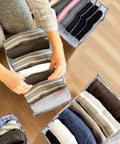 Person organizing clothes in 18 Piece Wardrobe Organizer Set With Foldable Drawer Dividers In Two Sizes 7 Grid And 9 Grid Space Saver