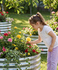 Child admiring flowers in 3-Pack Round Galvanized Raised Garden Bed Kit 2 By 2 By 1 Foot Outdoor Planter Metal Flower Box