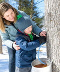 Child collects maple sap using Easy Flow 33 Feet Maple Syrup Tubing Set, 5 16 Inch Vacuum Silicone Sap Line for Maple Trees.