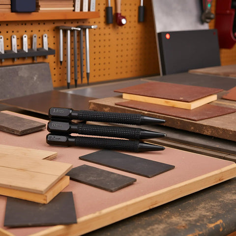 3 Piece Center Punch Set With 4 Inch High Carbon Steel Black Finish Pro Grade Hand Tools displayed on workbench with wood and alloy surfaces