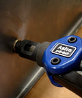 Close-up of 13-Inch Nut And Thread Hand Riveter Kit With Toolless Quick-Change Head in use on metal surface.