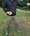 Man demonstrating use of Throw Weight Pouch Set For Arborist Tree Climbing, 2 Pack, 8 Oz And 12 Oz, Luminous Yellow.