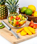 Pineapple Eye Remover Tool With V Shaped Stainless Steel Blade on cutting board beside fruit, showcasing multipurpose use.