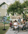Family gathering outdoors with 18 Inch Oscillating High Velocity Outdoor Pedestal Misting Fan With 3 Speed Settings, Adjustable Height