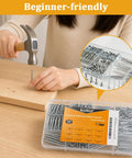 Picture Hanging Nails And Wood Screws Kit With 205 Finishing Nails And 145 Flat Head Screws shown in use with hammer