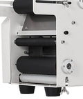 Mt 50 Semi Automatic Bottle Labeling Machine With Electrical Adhesive Printer showing detail of roller mechanism for bottle labeling.