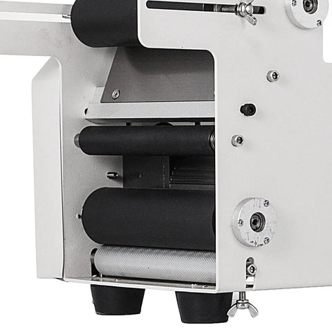 Mt 50 Semi Automatic Bottle Labeling Machine With Electrical Adhesive Printer showing detail of roller mechanism for bottle labeling.