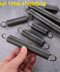 Heavy Duty Tension Springs With Open Hooks Made From Strong Spring Steel 65Mn in hand, showcasing various sizes for mechanics.