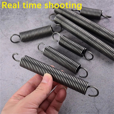 Heavy Duty Tension Springs With Open Hooks Made From Strong Spring Steel 65Mn in hand, showcasing various sizes for mechanics.