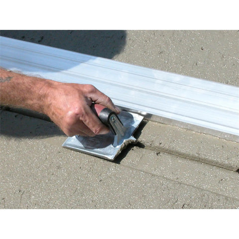 Using the Heavy Duty Zinc Concrete Groover With DuraSoft Handle 6 By 4 And Three Eighths Inch Blade on fresh concrete surface.
