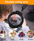 Person using 10X Magnifying Glass With Light And Stand for electronics repair, hands-free close work with flexible swing arm.