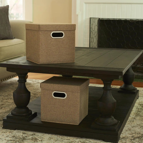 Heavy Duty Foldable Cube Storage Bins With Secure Snap Lids And Polished Chrome Handles In Warm Brown Linen Fabric For Closets Shelves And Bedroom Organization No Hassle Top Shelf American Craft on a coffee table.