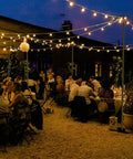 Outdoor wedding scene with Heavy Duty Outdoor String Light Poles 9 Ft Two Pack For Backyard Patio Lights, creating bistro vibe.