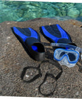Diving fins, mask, and Stretchy Diving Tank Cylinder Band Retainer for Scuba Gear on a rock by the sea