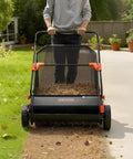 Heavy Duty Push Lawn Sweeper With 30 Inch Wide Broom And 12 Cubic Foot Hopper Bag For No Sweat Grass And Leaf Pickup Across Big Lawns Patios Sidewalks And Driveways in use on grass.