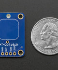 Capacitive Touch Sensor Breakout Module, Momentary Switch Action, No Microcontroller Needed, 1.8V to 5.5V Power, Compact 20mm By 28mm Board next to a quarter for scale.