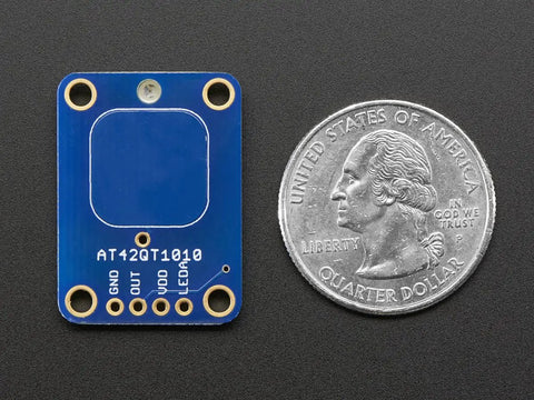 Capacitive Touch Sensor Breakout Module, Momentary Switch Action, No Microcontroller Needed, 1.8V to 5.5V Power, Compact 20mm By 28mm Board next to a quarter for scale.