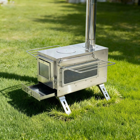 Stainless Steel Portable Tent Stove with Crack Resistant Ceramic Glass for outdoor camping, on green lawn with chimney and legs.