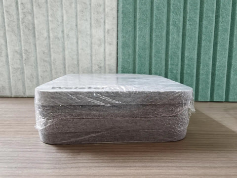 Snag This 4 Pack Of Polyester Fiber Acoustic Panels Self Adhesive Sound Proof Tiles 0.4 Inch Thick stacked on a surface.