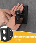 Hand installing 8 Pack Heavy Duty 2x4 Door Barricade Brackets U Shaped Wood Mount Security Bar Holders, black, on wall.