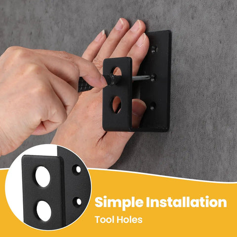 Hand installing 8 Pack Heavy Duty 2x4 Door Barricade Brackets U Shaped Wood Mount Security Bar Holders, black, on wall.