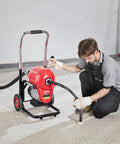 Heavy Duty Electric Sewer Snake Drain Cleaner Machine With 120 Ft Steel Cable And 1100 Watt Motor in use by a technician.