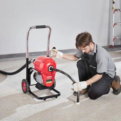 Heavy Duty Electric Sewer Snake Drain Cleaner Machine With 120 Ft Steel Cable And 1100 Watt Motor in use by a technician.