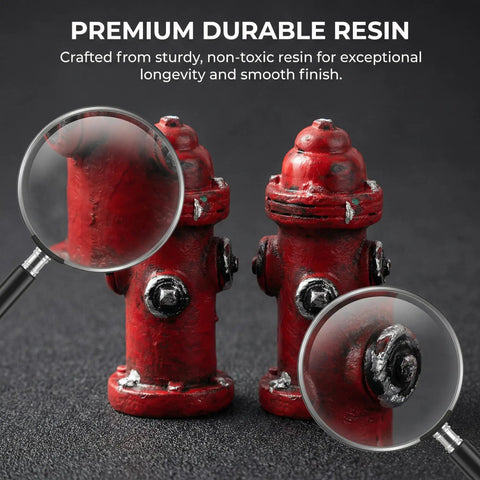Close-up of two red resin fire hydrant figurines, 1.77 inches tall, for dollhouse decor and crafts, shown with magnifying glasses.