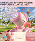 Magical Pink Unicorn Bubble Machine For Toddlers Ages Two To Four, Portable Electric Toy generating colorful bubbles outdoors.