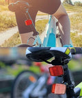 Cyclist with 2 Pack Bike Front And Rear Reflectors Kit For Mountain Bikes on seat post, enhancing visibility.