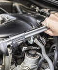 Using an 11 inch automotive wrench with big jaw capacity to adjust fasteners in a car engine, showcasing a heavy duty build.