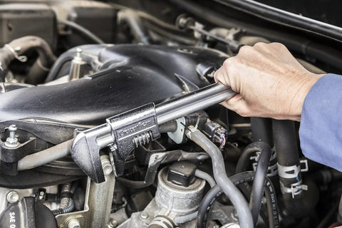 Using an 11 inch automotive wrench with big jaw capacity to adjust fasteners in a car engine, showcasing a heavy duty build.