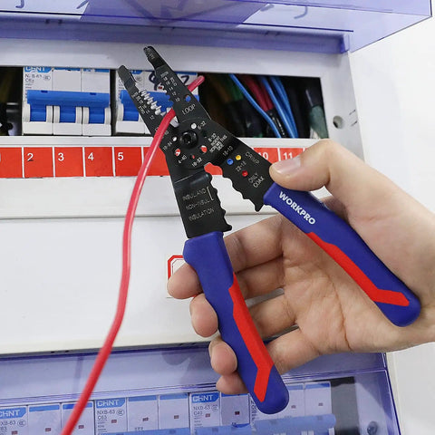 Hand holding All-In-One 8-Inch Wire Stripper And Multi-Tool Cutter for stripping, cutting, and crimping wires in electric panel
