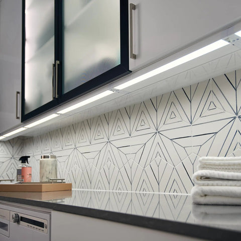 22 Inch LED Under Cabinet Light 120V Warm White 3000K Diffused Pure White Glow in modern kitchen with geometric tiles