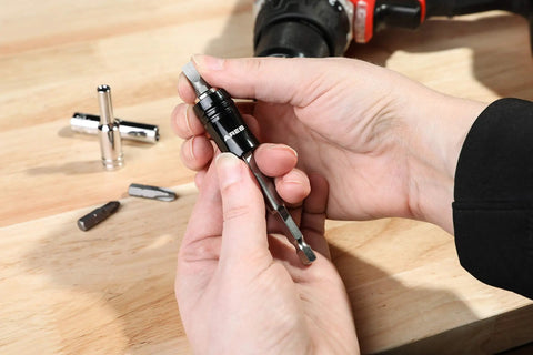 2 In 1 Socket Bit Holder For One Quarter Inch Drive Sockets And Bits With Quick Change Mechanism in hand on wooden surface