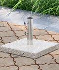 Heavy Duty Granite Patio Umbrella Base With Handle And 2 Casters in outdoor setting, square grey stone, fits 1.5 inch poles