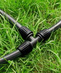 10 Pack Half Inch Drip Irrigation Barbed Tee Connectors With Locked Nut Anti Drop attached to tubing on grass