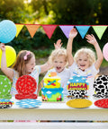 Three kids celebrate with Legendary 7 Inch Cartoon Story Paper Plates 60 Pack Boy Birthday Party Supplies, colorful designs included.