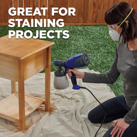 Person using Quick Finish HVLP Paint Sprayer for Crafting and Furniture on a wooden table, showcasing adjustable spray settings.