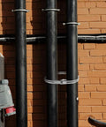 Heavy Duty Stainless Steel Pex Clamps With Quick Release Design For Plumbing Fittings securing pipes against a brick wall