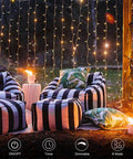 Outdoor setup with chairs and Battery Operated Fairy Curtain Lights With Remote Timer Nine Point Eight Feet By Nine Point Eight Feet Of Warm White LEDs